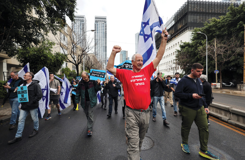  An Israeli man wears a T-shirt that reads ‘You don’t switch a democracy at the ballot box’ during a hi-tech sector protest in Tel Aviv on March 14, 2023. (photo credit: NIR ELIAS/REUTERS)