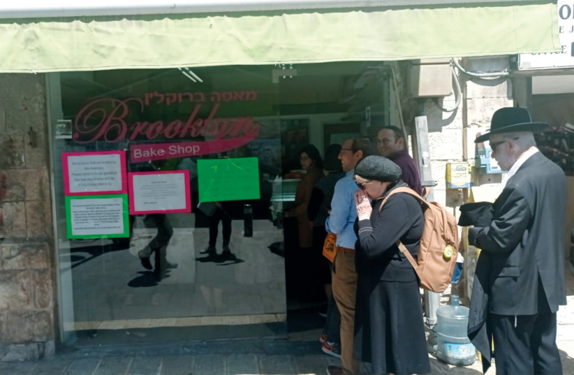 A line of customers are seen outside the Brooklyn Bake Shop in Jerusalem's Mea She'arim in one of its last days in business, on March 30, 2023. (photo credit: AARON REICH)