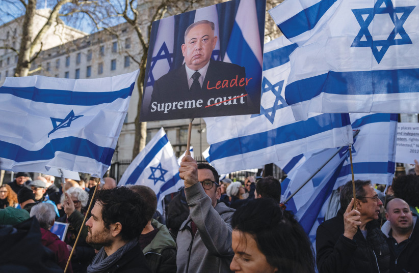  LONDON DEMONSTRATORS – one carrying a likeness of Benjamin Netanyahu as a North Korean dictator – gather near Downing Street ahead of the premier’s arrival, March 24. (photo credit: Martin Pope/Getty Images)