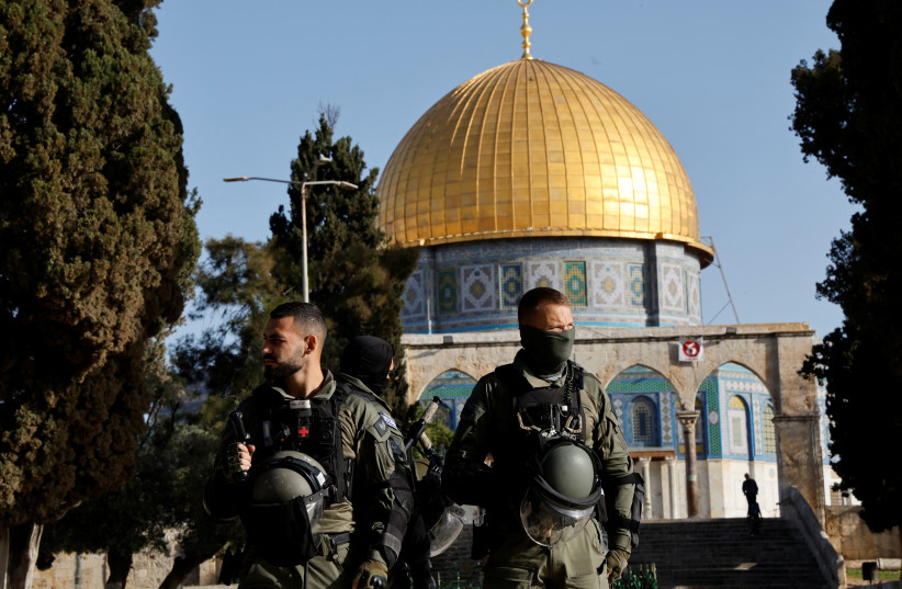 Israeli security forces work at the Al-Aqsa compound, also known as the Temple Mount, while tension arises during clashes with Palestinians in Jerusalem's Old City, April 5, 2023 (photo credit: AMMAR AWAD/REUTERS)