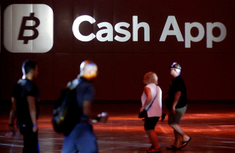 The logo of Cash App is seen at the main hall during the Bitcoin Conference 2022 in Miami Beach, Florida, US April 6, 2022. (photo credit: REUTERS/Marco Bello/File Photo)