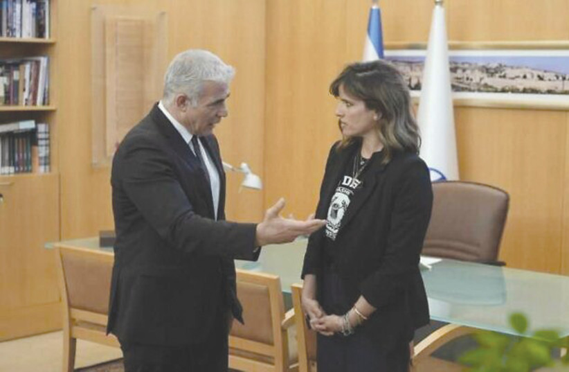  THEN-FOREIGN MINISTER Yair Lapid greets Noa Tishby after her appointment as special envoy to combat antisemitism and delegitimization, last April in Jerusalem. (photo credit: FOREIGN MINISTRY)