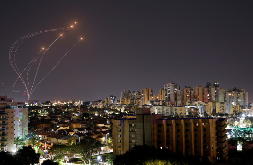  Streaks of light are seen as Israel's Iron Dome anti-missile system intercept rockets launched from the Gaza Strip, as seen from Ashkelon, April 7, 2023. (photo credit: AMIR COHEN/REUTERS)