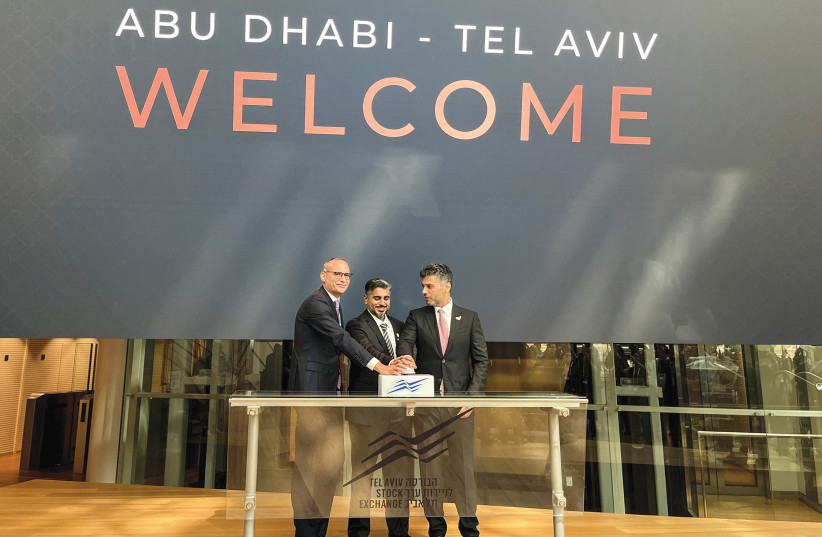  FROM LEFT: Ittai Ben-Zeev, CEO of the Tel Aviv Exchange; Muhanned al-Khaja, UAE ambassador to Israel; and Ahmed al-Zaabi, chairman of Abu Dhabi Global Markets, open a trading day at the TASE, last September. (photo credit: STEVEN SCHEER/REUTERS)