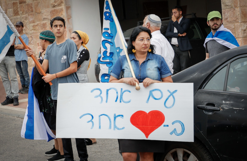 Family and friends gather outside the house of Maia and Rina Dee, ahead of their funeral in Efrat on April 09, 2023. The 2 sisters were killed 2 days ago in a terror attack in the Jordan valley. Their mother, injured in the attack, is still in critical condition.