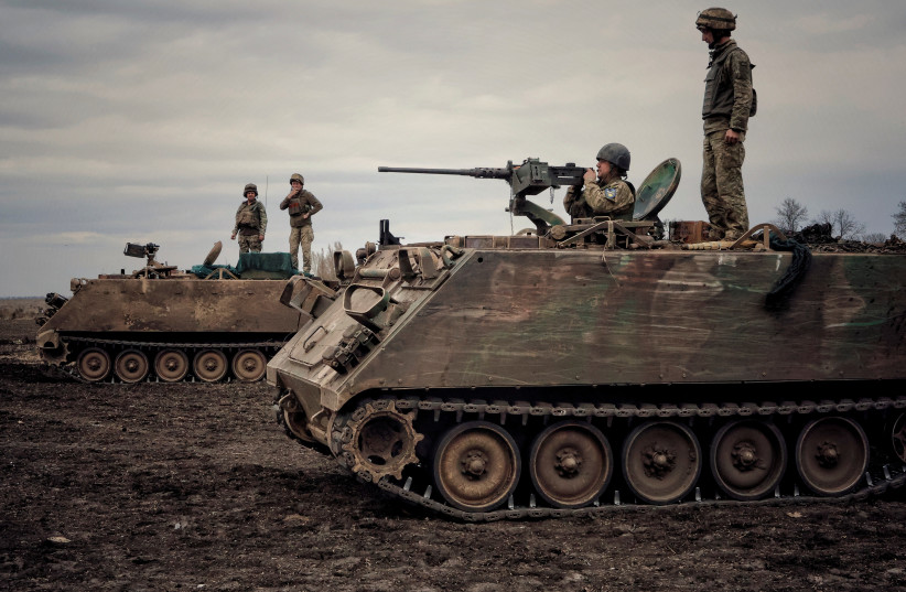  Ukrainian servicemen train to shoot a machine gun from M113 Armoured Personnel Carrier (APC) during a training session, amid Russia's invasion of Ukraine, in Donbas region, Ukraine April 8, 2023. (photo credit: Yan Dorbronosov/Reuters)
