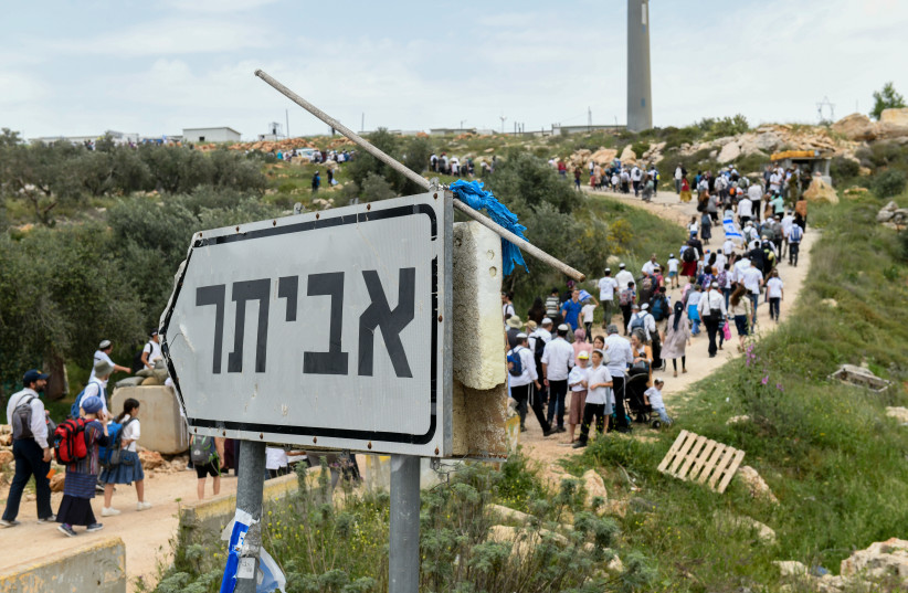  Israeli Jews are seen marching to the Evyatar outspot, near the West Bank city of Nablus, during the Passover holiday, on April 10, 2023.  (photo credit: SRAYA DIAMANT/FLASH90)