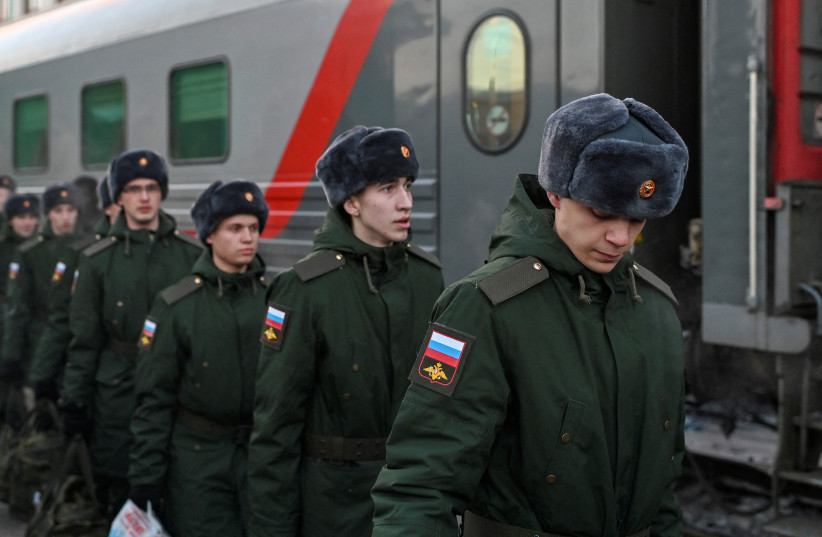  Russian conscripts called up for military service walk along a platform before boarding a train as they depart for garrisons at a railway station in Omsk, Russia November 27, 2022.  (photo credit: REUTERS/ALEXEY MALGAVKO)