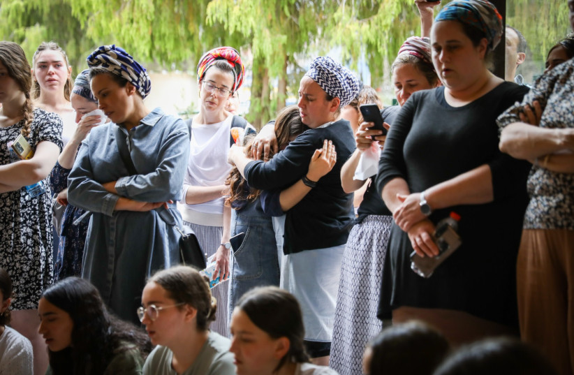 Family and friends attend the funeral of Maia and Rina Dee at the Gush Etzion Regional Cemetery in Kfar Etzion on April 9, 2023. (photo credit: NOAM REVKIN FENTON/FLASH90)