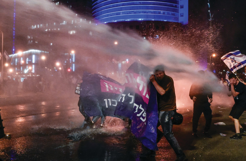  POLICE BLAST water cannons to disperse protesters in Tel Aviv, March 27. (photo credit: AVSHALOM SASSONI/FLASH90)