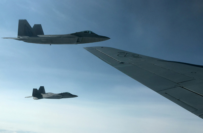  Two U.S. Air Force F-22 stealth fighter jets are about to receive fuel mid-air from a KC-135 refueling plane over Norway en route to a joint training exercise with Norway's growing fleet of F-35 jets August 15, 2018. (photo credit: REUTERS)