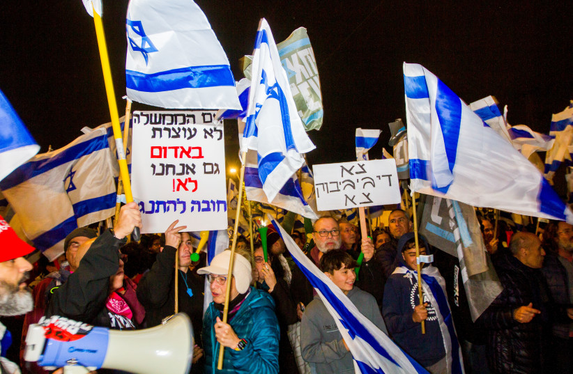  Israelis who oppose the Israeli government's planned judicial overhaul protest outside a Mimuna event attended by Prime Minister Benjamin Netanyau and his wife Sara, in Hadera on April 12, 2023.  (photo credit: FLASH90)