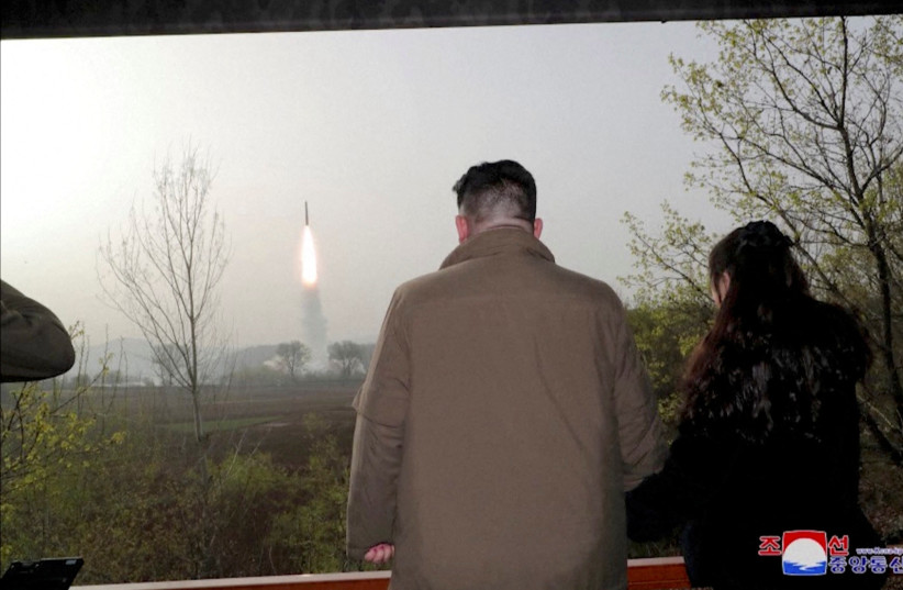  North Korean leader Kim Jong Un and his daughter Kim Ju Ae watch a test launch of a new solid-fuel intercontinental ballistic missile (ICBM) Hwasong-18 at an undisclosed location in this still image of a photo used in a video released on April 14, 202 (credit: KCNA/VIA REUTERS)