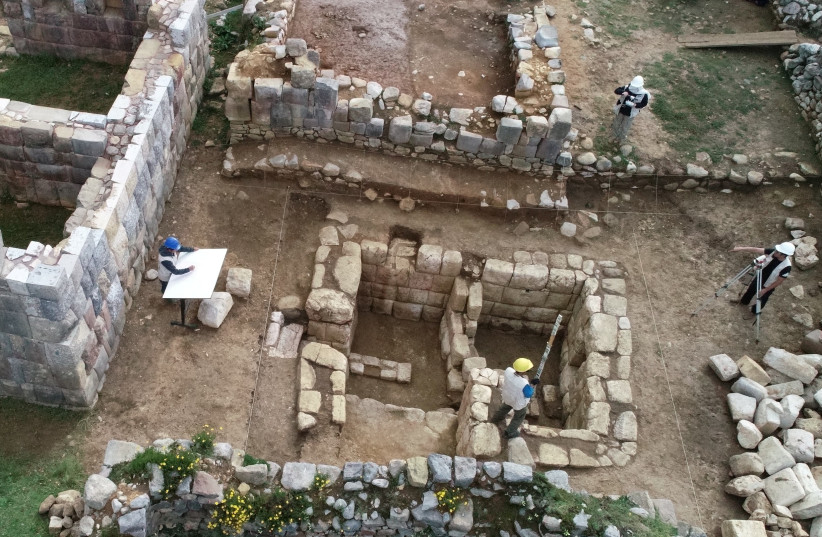 Archaeologists work in the remains of an ancient ceremonial Inca bathroom, discovered in a sector known as Inkawasi (House of the Inca), at the archaeological site Huanuco Pampa, in Huanuco, Peru April 5, 2023. (photo credit: Peru Culture Ministry/Handout via REUTERS)