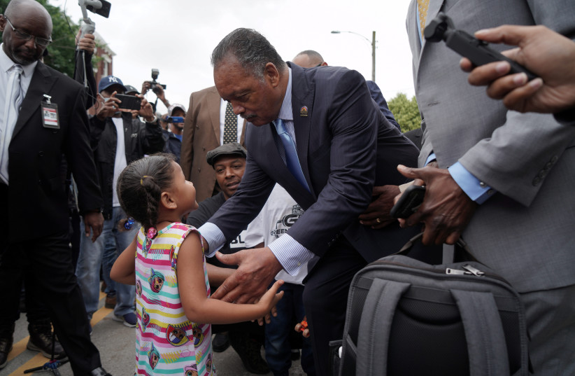 Reverend Jesse Jackson greets a little girl in the crowd during the 100th anniversary of the 1921 Tulsa Massacre in Tulsa, Oklahoma, U.S., June 1, 2021. (photo credit: REUTERS/LAWRENCE BRYANT)