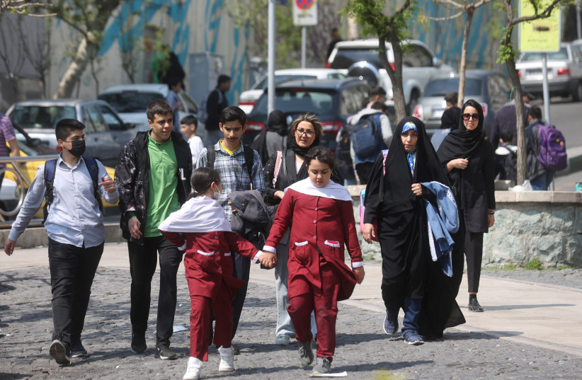  Iranian women walk on a street amid the implementation of the new hijab surveillance in Tehran, Iran, April 15, 2023. (photo credit: Majid Asgaripour/WANA/via Reuters)