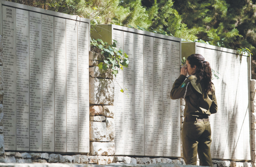 AN IDF soldier looks at names engraved on the Wall of Honor in the Garden of the Righteous Among the Nations at Yad Vashem. ‘In certain circles, the memory of the Righteous is used to suppress research on the Holocaust.’
