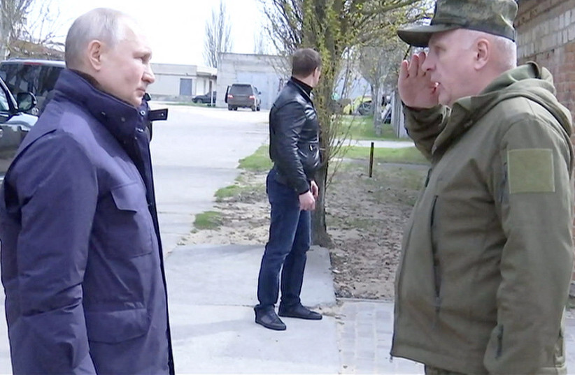  Russian President Vladimir Putin listens to Colonel General Oleg Makarevich, commander of the Dnieper Group of Forces, during his visit to the headquarters of the "Dnieper" army group in the Kherson Region, Russian-controlled Ukraine, in this still image taken from handout video  (photo credit: KREMLIN.RU/HANDOUT VIA REUTERS)