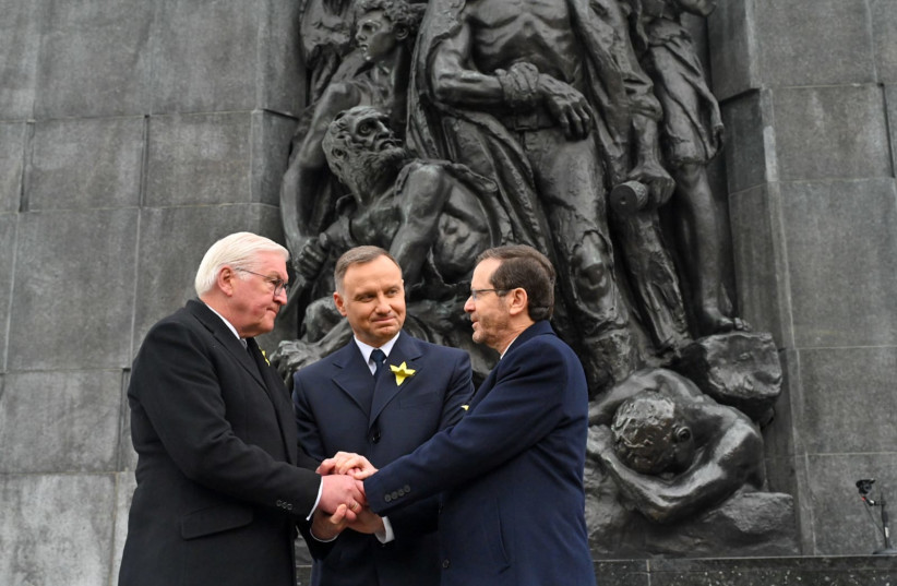  President Isaac Herzog together with German President Frank-Walter Steinmeier and Polish President Andrzej Duda, in a joint handshake at the Monument to the Ghetto Heroes at the end of the main ceremony (photo credit: KOBI GIDEON/GPO)