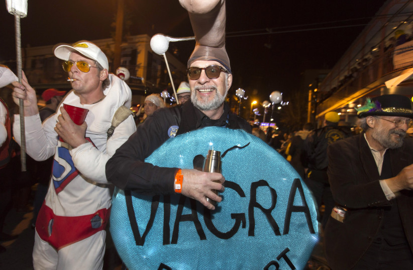  A man in a Viagra costume marches in the Krewe du Vieux 2015 parade, the first parade of the Mardi Gras festivities, through the French Quarter in New Orleans January 31, 2015 (credit: REUTERS/LEE CELANO/FILE PHOTO)