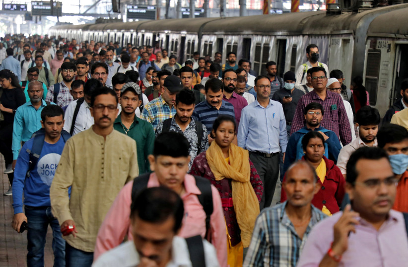  Commuters walk on a platform after disembarking from a suburban train at a railway station in Mumbai, India, January 21, 2023. (photo credit: REUTERS/NIHARIKA KULKARNI)