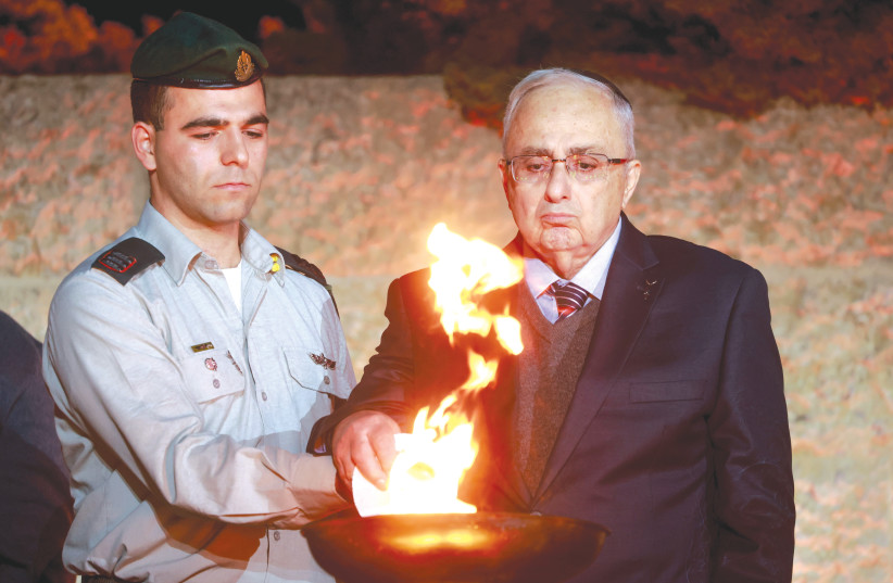  A HOLOCAUST survivor lights a torch at Yad Vashem at the state ceremony marking the beginning of Holocaust Martyrs' and Heroes' Remembrance, on Monday night (photo credit: ERIK MARMOR/FLASH90)
