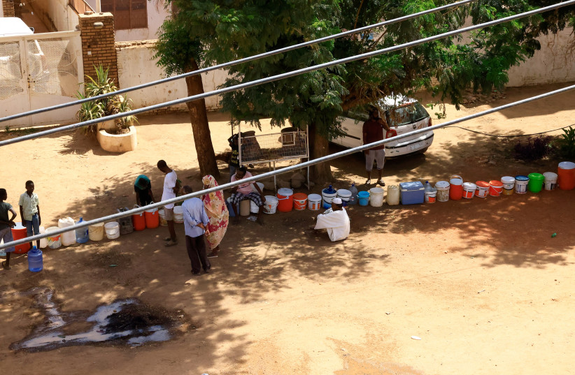  People wait to get water during clashes between the paramilitary Rapid Support Forces and the army in Khartoum North, Sudan, April 22, 2023.  (credit: REUTERS/MOHAMED NURELDIN ABDALLAH)