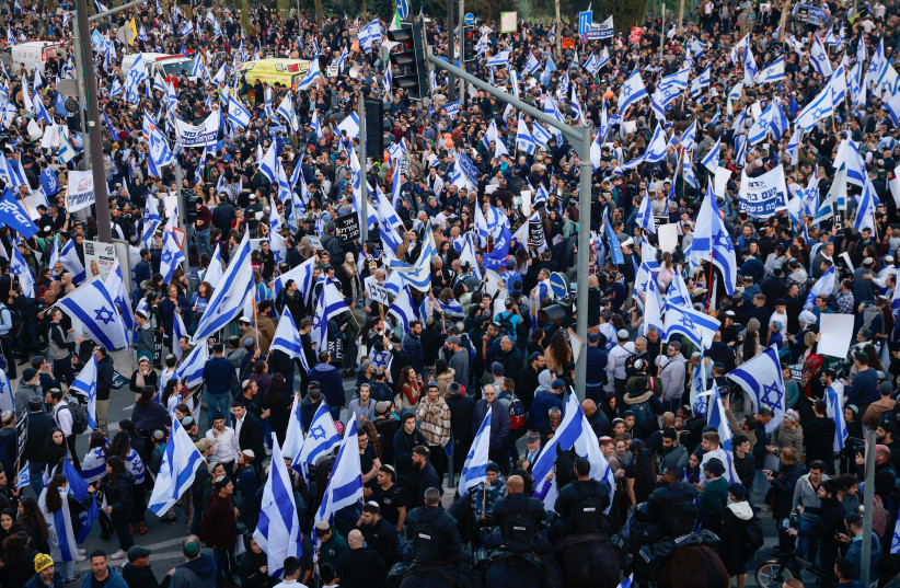  PROTESTERS HOLD Israeli flags during a demonstration against the government’s judicial overhaul plan in Tel Aviv on April 15, 2023. (photo credit: NIR ELIAS/REUTERS)