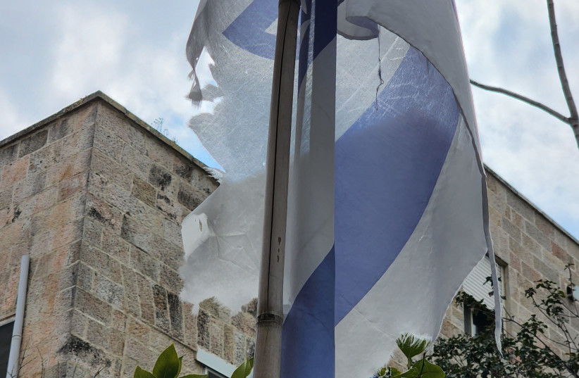  A TATTERED Israeli flag hangs in Jerusalem. (credit: Yosef Israel Abramowitz)