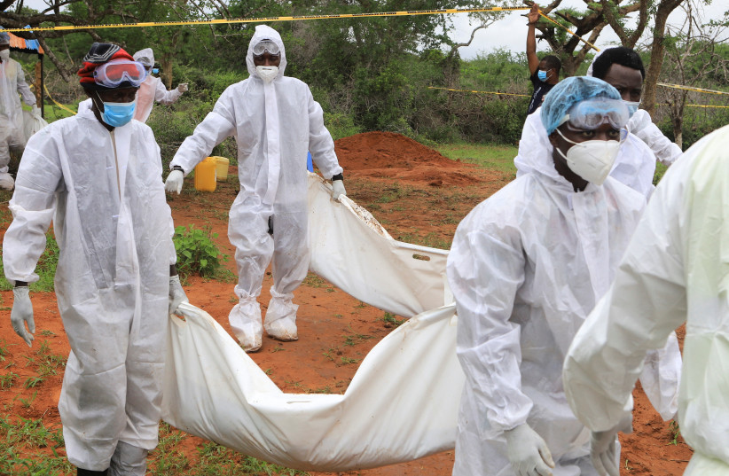  Forensic experts and homicide detectives carry the bodies of suspected members of a Christian cult named as Good News International Church, who believed they would go to heaven if they starved themselves to death, after their remains were exhumed from their graves in Shakahola forest of Kilifi coun (credit: REUTERS/STRINGER)