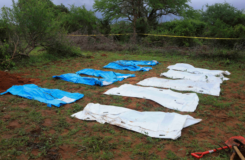  Body bags are seen arranged as forensic experts and homicide detectives exhume bodies of suspected members of a Christian cult named as Good News International Church, who believed they would go to heaven if they starved themselves to death, in Shakahola forest of Kilifi county, Kenya April 22, 202 (credit: STRINGER/ REUTERS)
