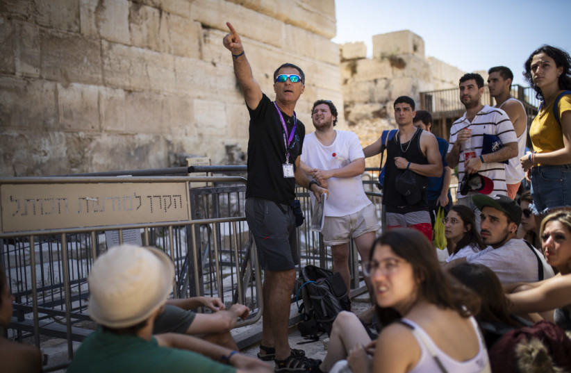  Tourists from Uruguay at Davidson's Center Archeological Park by the Western Wall, after exiting the City of David's main drainage tunnel that leads from the Siloam Pool up to the Temple Mount, during their visit to the City of David National Park and Jerusalem's Old City, on July 22, 2019.  (photo credit: HADAS PARUSH/FLASH90)