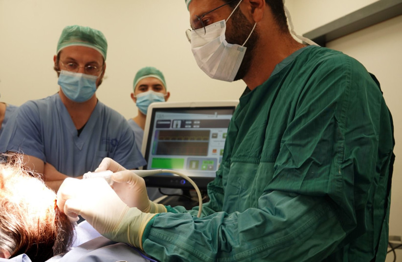  Shaare Zedek Medical Center doctors performing a skin cancer treatment procedure (photo credit: SHAARE ZEDEK MEDICAL CENTER)