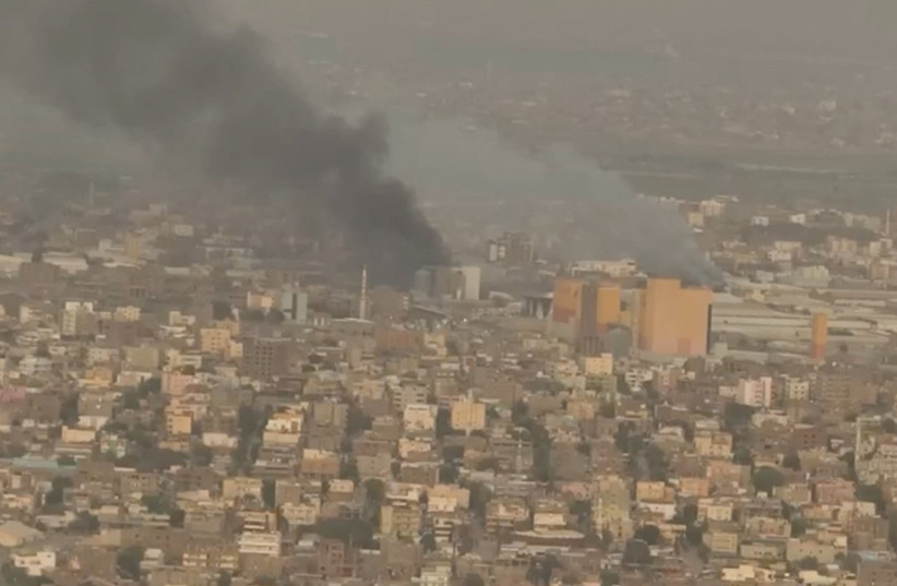  A drone view shows smoke rising over the Khartoum North Light Industrial Area, in Bahri, Sudan, April 23, 2023, in this still image taken from video obtained by Reuters.  (credit: VIDEO OBTAINED BY REUTERS/VIA REUTERS)