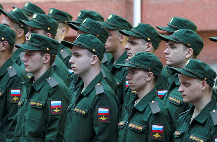  Russian conscripts called up for military service line up before their departure for garrisons as they gather at a recruitment centre in Simferopol, Crimea, April 25, 2023. (photo credit: REUTERS/ALEXEY PAVLISHAK)