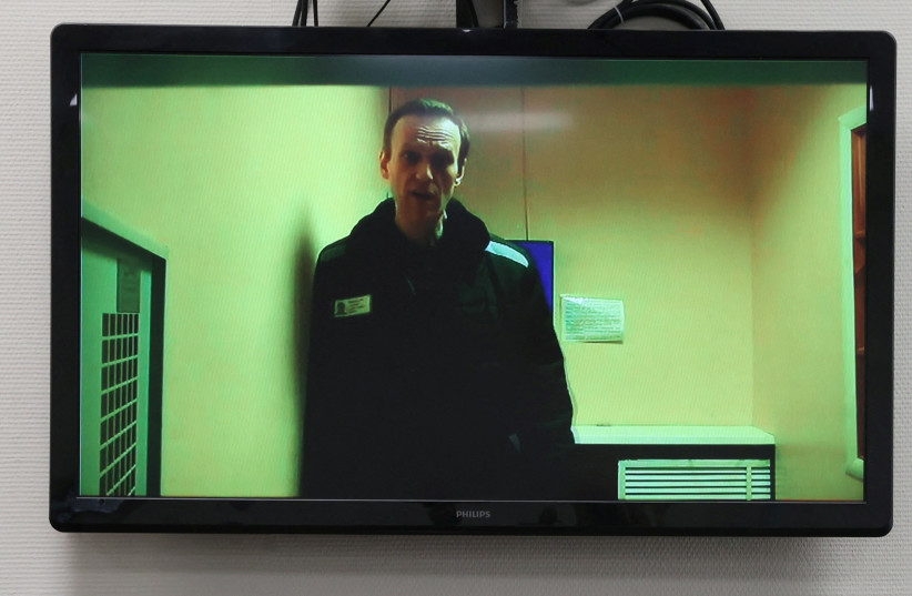  Russian opposition leader Alexei Navalny is seen on a screen via video link from a penal colony in the Vladimir Region during a hearing at the Basmanny district court in Moscow, Russia April 26, 2023 (photo credit: REUTERS/Yulia Morozova)