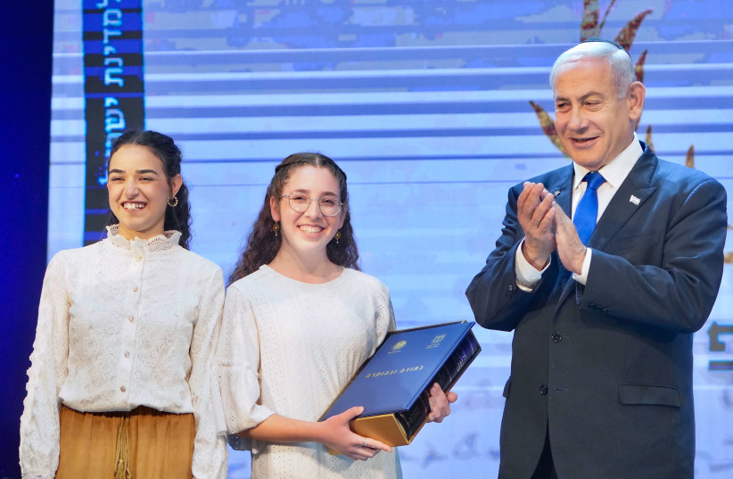 Prime Minister Benjamin Netanyahu with winners of the Bible Quiz at the annual Bible Quiz held at the Jerusalem Theatre on Israel's Independence Day, on April 26, 2023. (credit: SHALEV SHALOM/POOL)