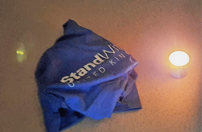  Memorial candle placed next to StandWithUs UK t-shirt after break-in (photo credit: StandWithUs UK)