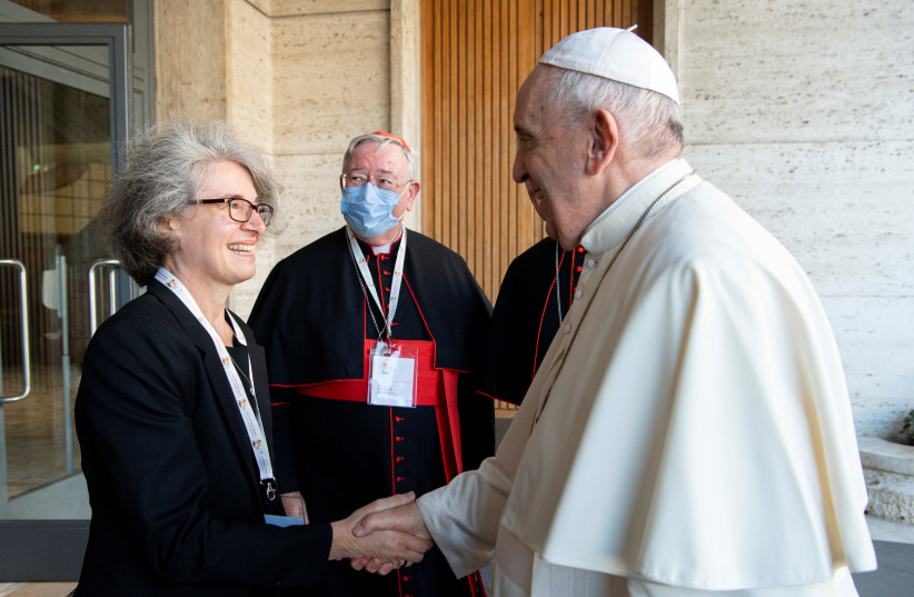 Sister Nathalie Becquart, co-undersecretary with voting rights in the Vatican Synod of Bishops, greets Pope Francis at the opening of the Synodal Path at the Vatican October 9, 2021. (photo credit: VATICAN MEDIA/HANDOUT VIA REUTERS)