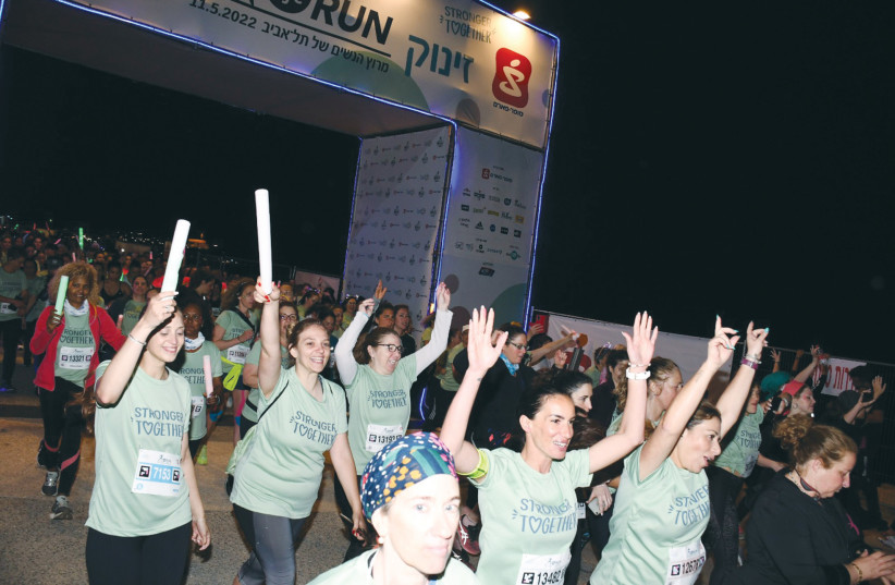  ARTICIPANTS WEAR shirts that read ‘Stronger together,’ at last year’s Life Run, in Tel Aviv. Running is a therapeutic tool.  (photo credit: AVIV HOFI)