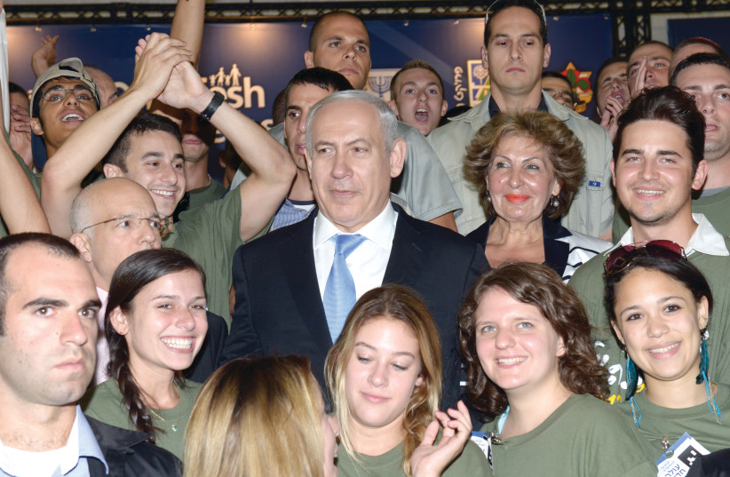  RIME MINISTER Benjamin Netanyahu attends a Nefesh B’Nefesh welcoming ceremony at Ben-Gurion Airport in 2012. (photo credit: AMOS BEN GERSHOM/GPO)
