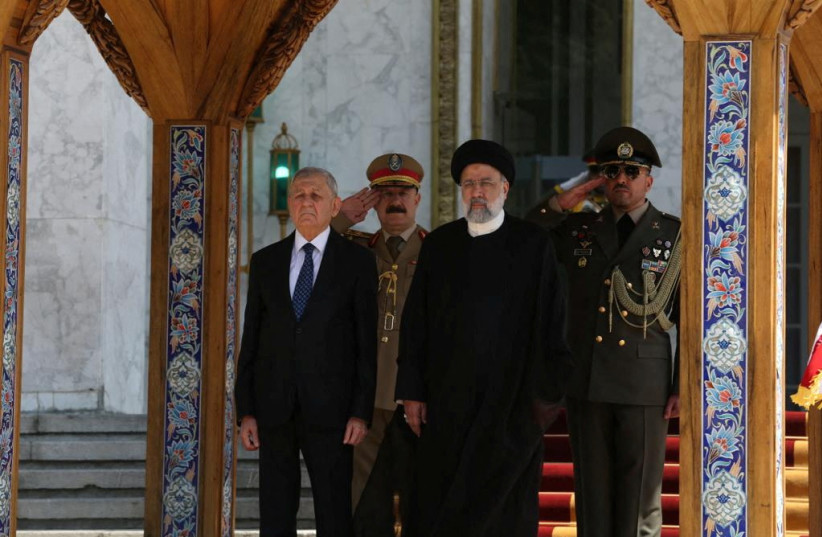  Iraqi President Abdul Latif Rashid and Iranian President Ebrahim Raisi, review an honour guard, during his official arrival ceremony in Tehran, Iran April 29, 2023.  (photo credit: Presidency of the Republic of Iraq Office/Handout via REUTERS)