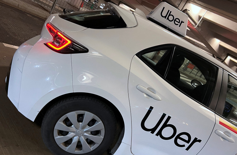  Uber branding is seen on private hire vehicle at Chopin Airport in Warsaw, Poland, March 22, 2023.  (credit: REUTERS/TOBY MELVILLE)