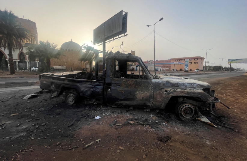  FILE PHOTO: A burned vehicle is seen in Khartoum, Sudan April 26, 2023 (photo credit: REUTERS/El-Tayeb Siddig/File Photo)