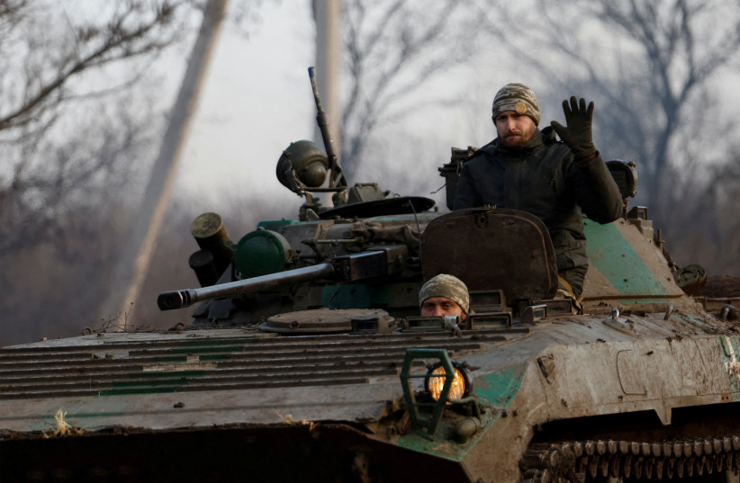  A Ukrainian serviceman waves from a tank, as Russia's attack on Ukraine continues, during intense shelling on Christmas Day at the frontline in Bakhmut, Ukraine, December 25, 2022. (credit: CLODAGH KILCOYNE/ REUTERS)