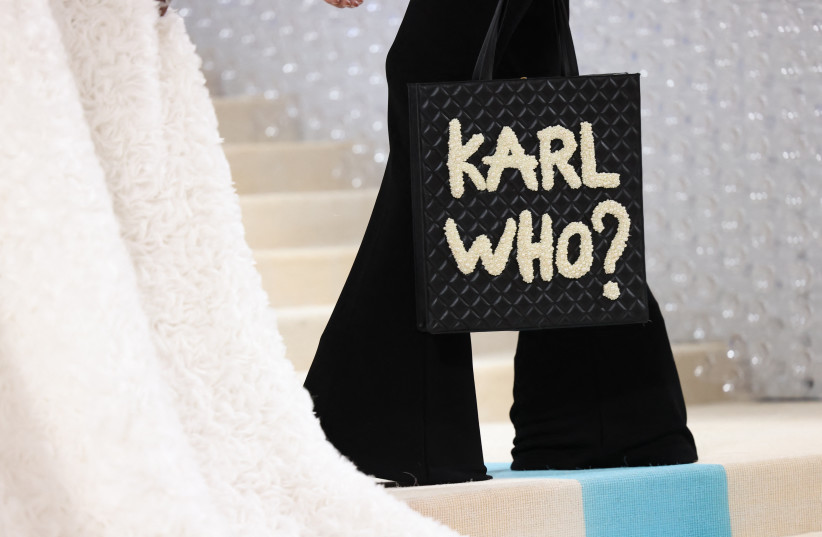  Jeremy Pope poses with a bag with the words "Karl Who?" at the Met Gala, an annual fundraising gala held for the benefit of the Metropolitan Museum of Art's Costume Institute with this year's theme "Karl Lagerfeld: A Line of Beauty", in New York City, New York, US, May 1, 2023.  (photo credit: REUTERS/ANDREW KELLY)