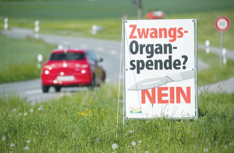  A POSTER of the Swiss People’s Party reads: ‘Forced organ donation? No,’ before the Swiss electorate voted on several issues in a referendum, last year. Switzerland is the country with the most aspects of direct democracy.  (photo credit: Arnd Wiegmann/Reuters)