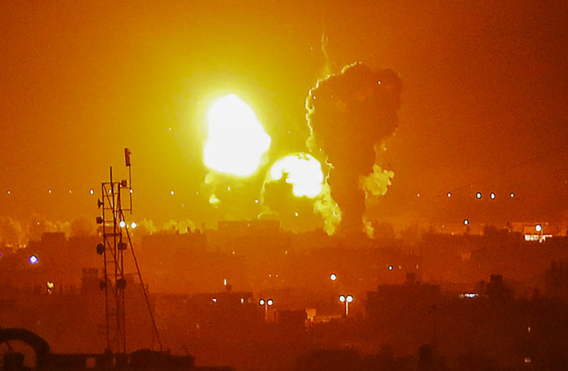  Flame and smoke are seen during an Israeli air strike in in Rafah, in the southern Gaza Strip, on May 3, 2023. (photo credit: ABED RAHIM KHATIB/FLASH90)