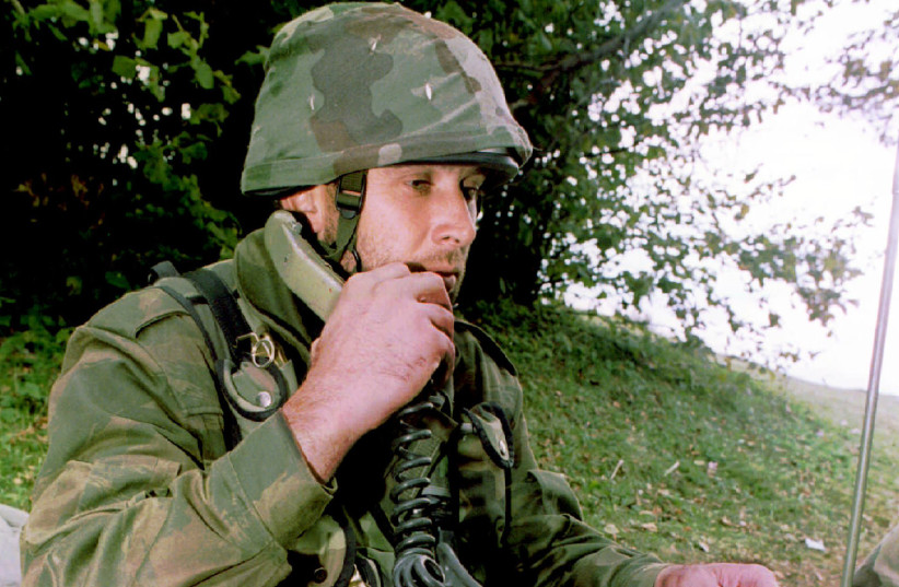 A Bosnian Serb soldier talks on a field-phone from a trench near the western Bosnian town of Kljuc October 4. Croatian radio reported armed conflict between Bosnian federal allies- Moslem and Croats in the area