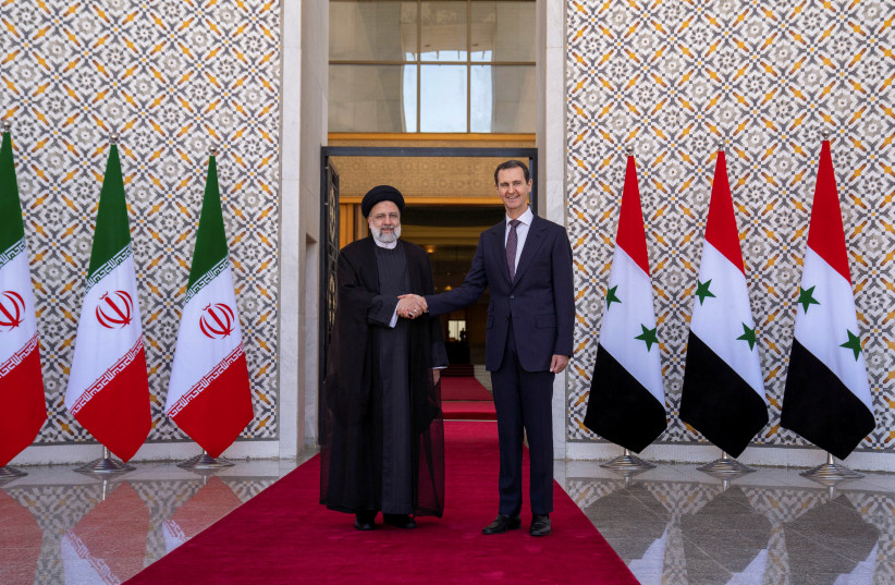  Syria's President Bashar Assad stands with Iranian President Ebrahim Raisi in Damascus, Syria, in this handout released by SANA on May 3, 2023.  (credit: SANA/HANDOUT VIA REUTERS)